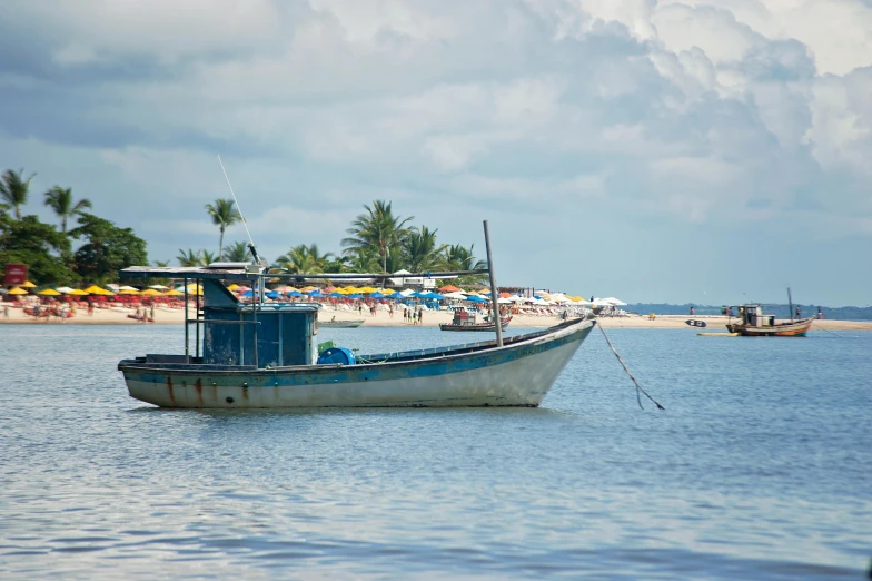 two boats are parked on the beach in the water