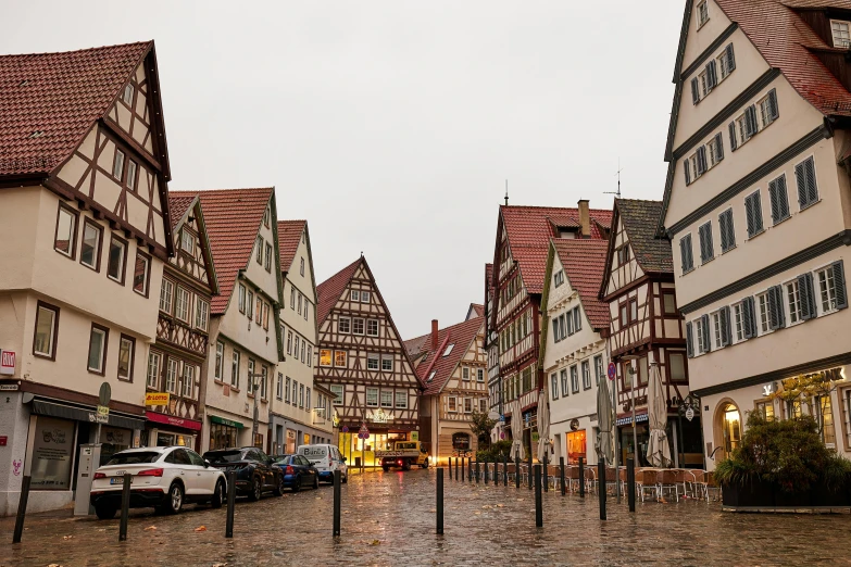 small houses with cars parked on the street near one another