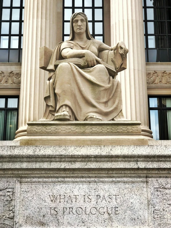 a statue of lady justice sitting on the top of the building