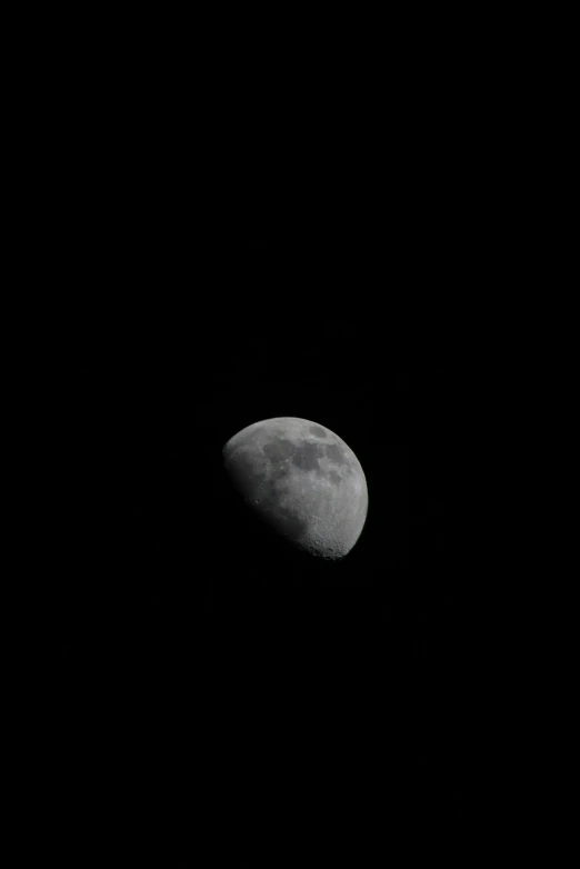 the moon in the black sky with a jet in the background