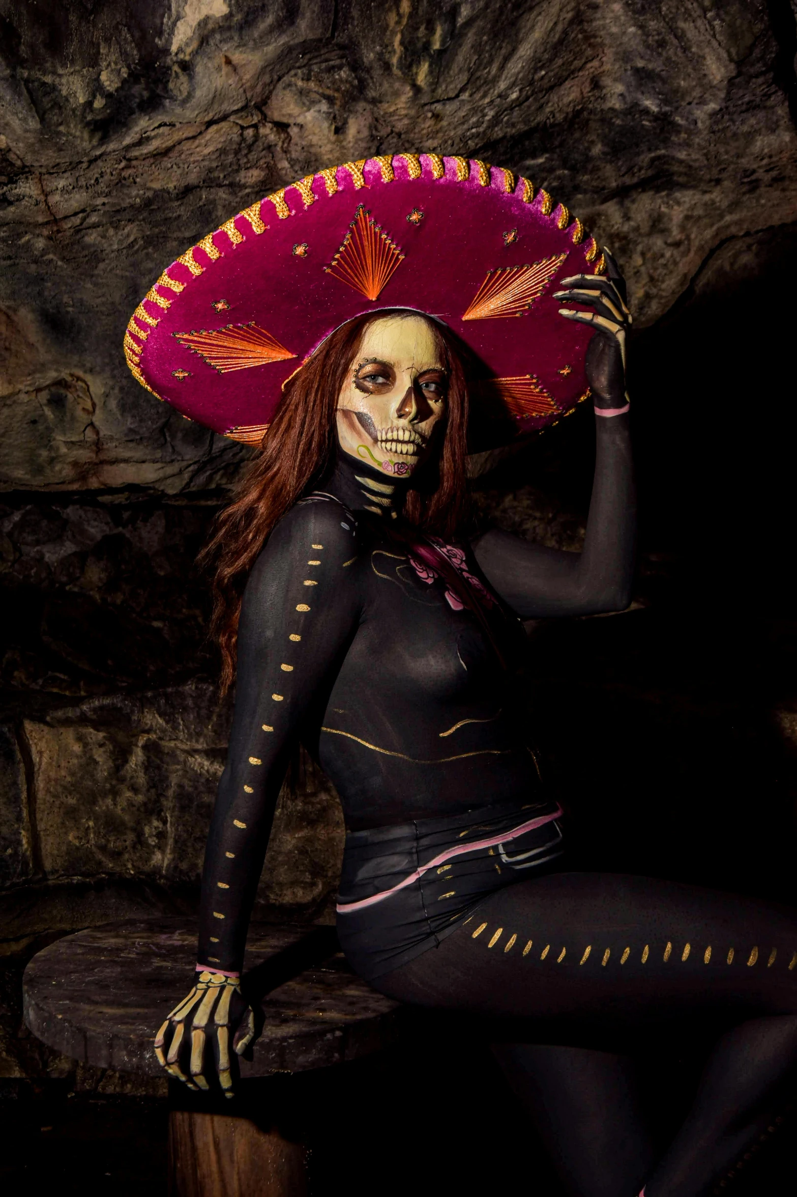 a woman in a skeleton costume poses for the camera