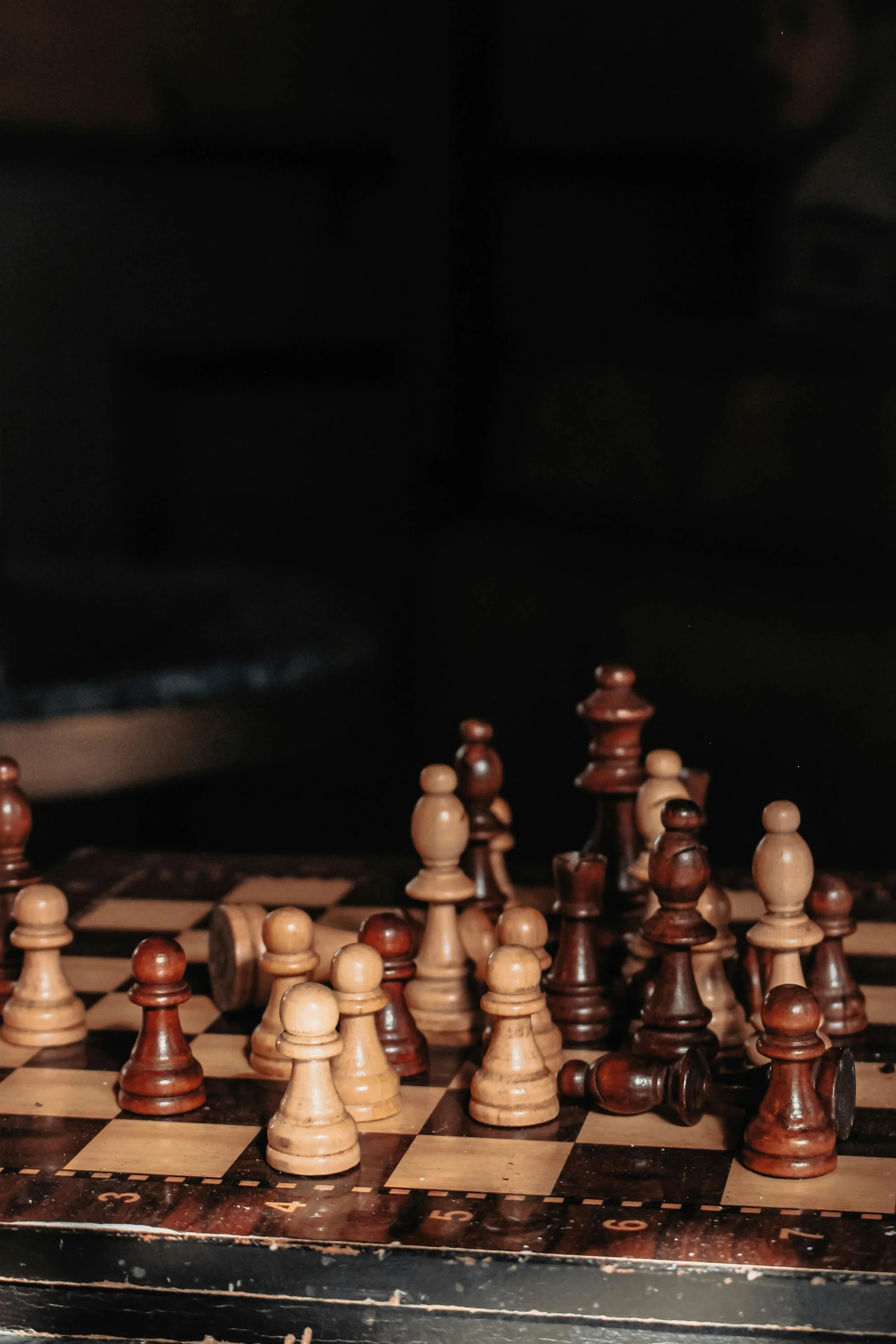 wooden chess board and pieces of brown, black and white chess