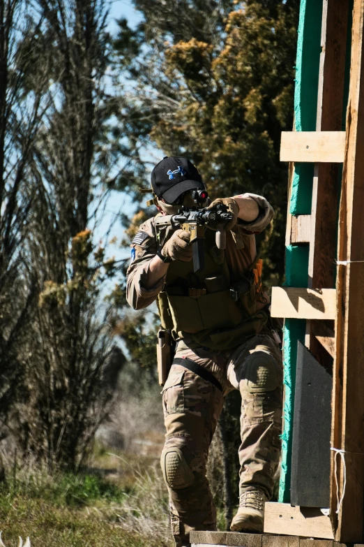 an army man with a rifle standing by a building