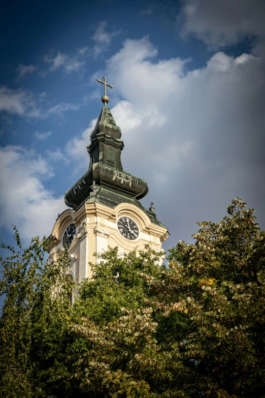 an ornate clock tower that has a weather vane on top