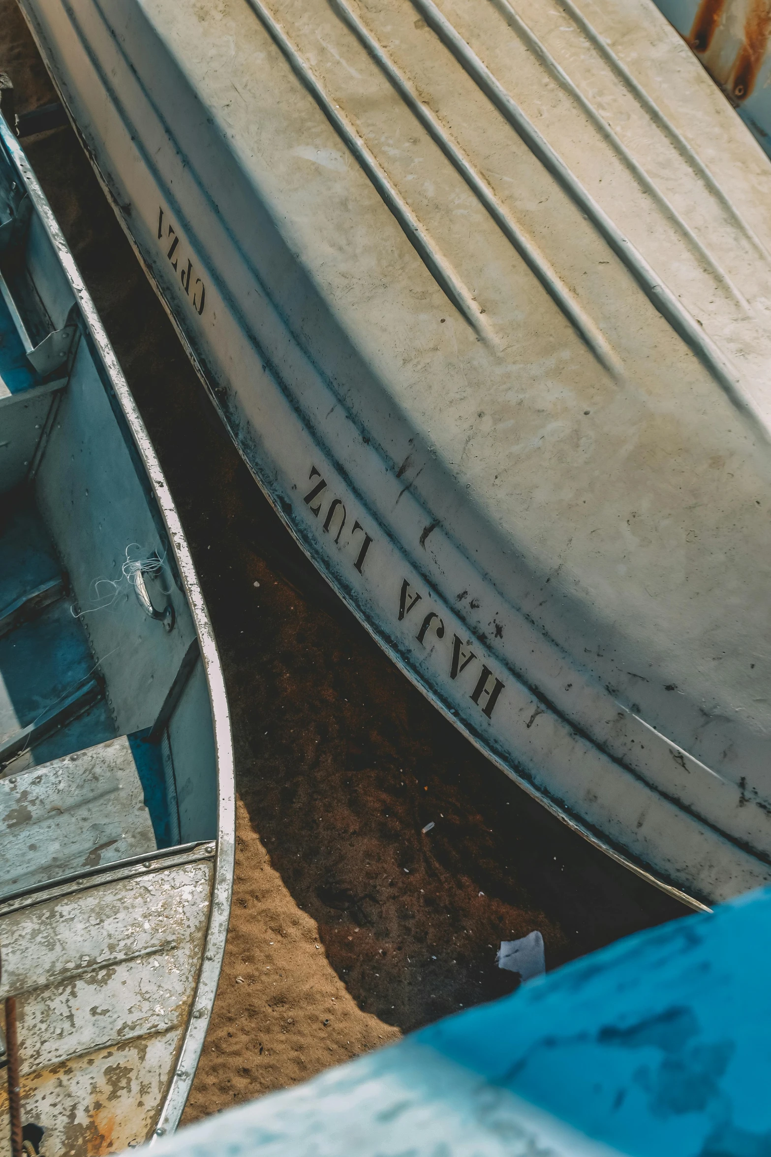 two old boat sitting next to each other in the water