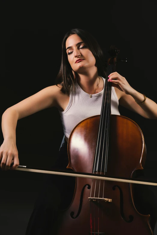 a girl is playing the bass with her hand