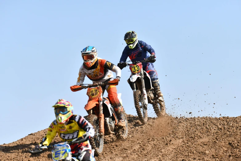 a group of dirt bikes going up a hill