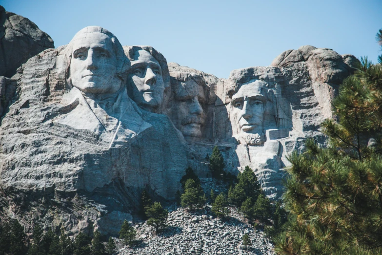 three stone carved presidents in the mountains