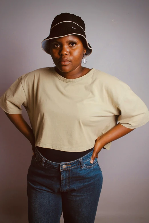 a woman standing in a white and black striped hat