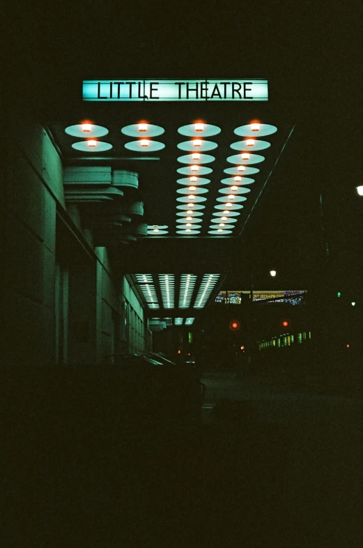 a bus stop with some lit up information