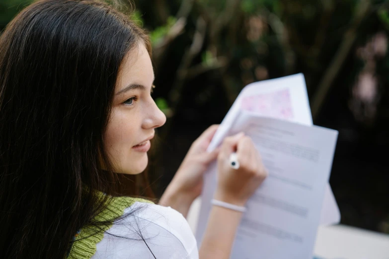 a girl holding up a piece of paper