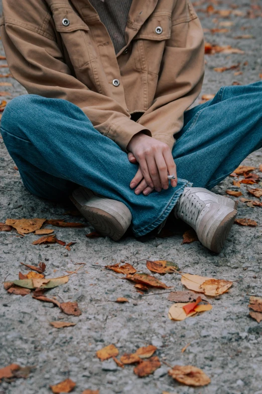 a person with their hand on his hip while sitting down