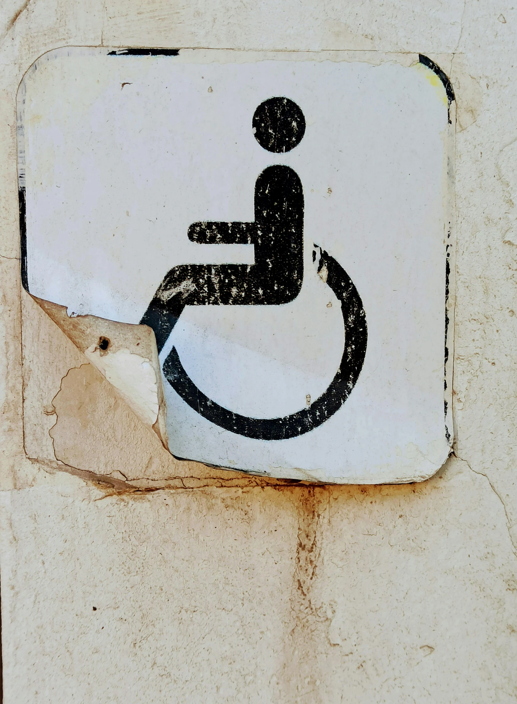 a handicapped sign is displayed on a white and black paper