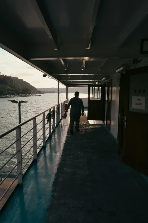 a man is walking down the pier toward the water
