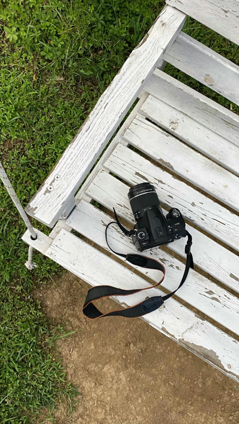 an old camera on top of a bench