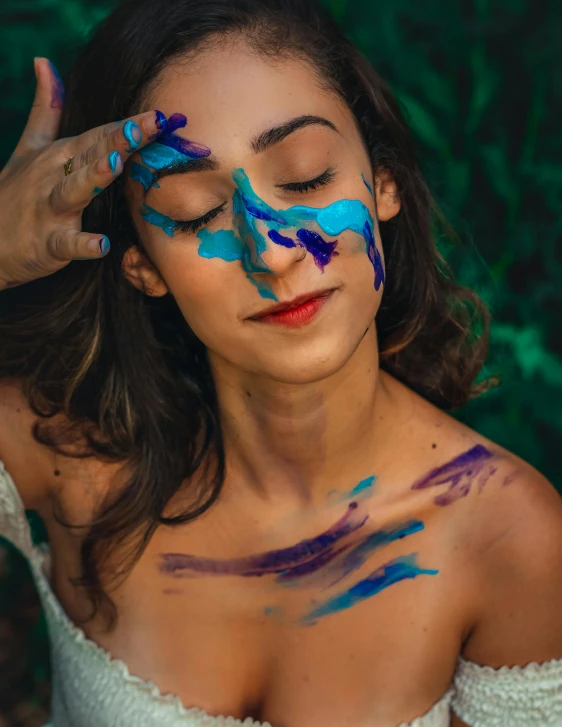 woman with painted skin showing artistically looking at camera