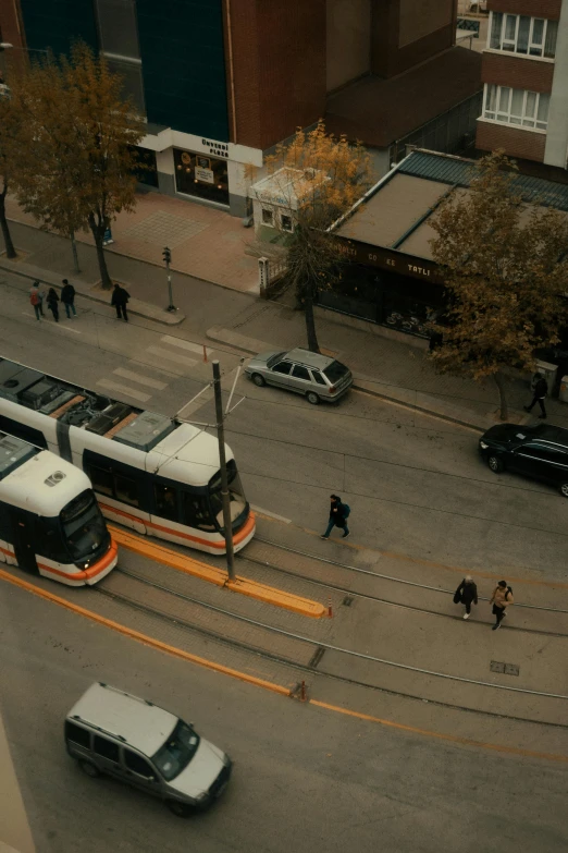 a city intersection with two buses and cars