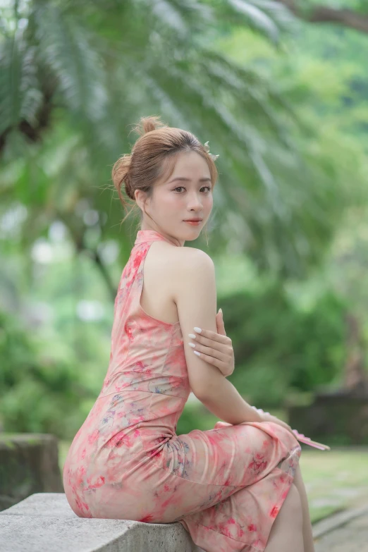 an attractive asian woman in a pink dress