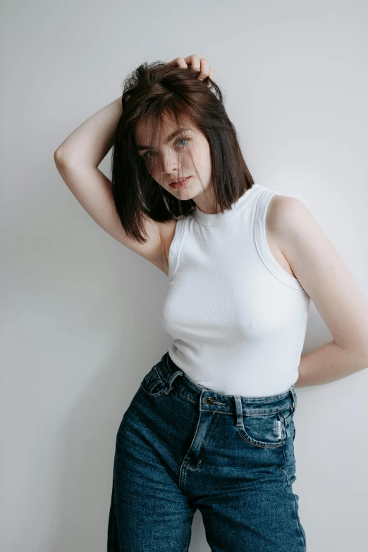 a young woman poses in denim jeans