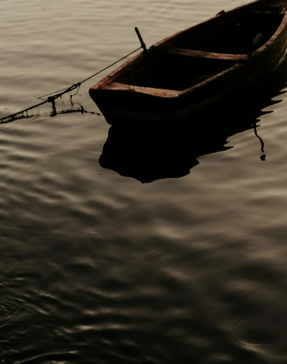 a row boat sits empty in the water