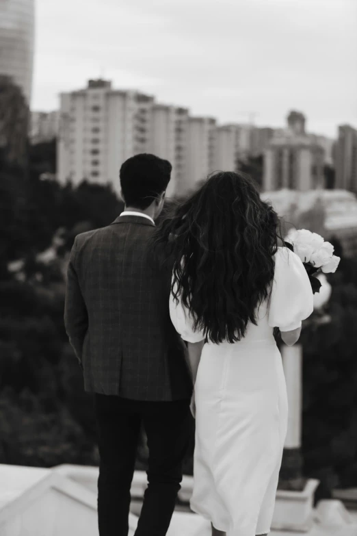 a man and woman walking across a street