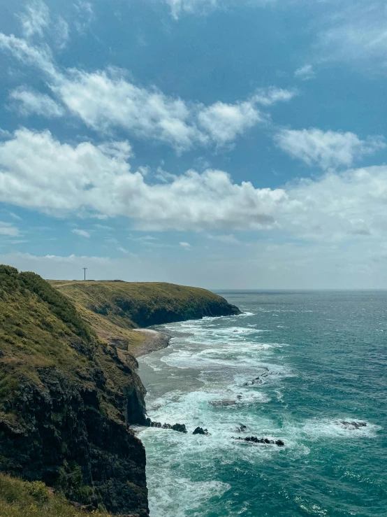 the view of a large body of water and a cliff