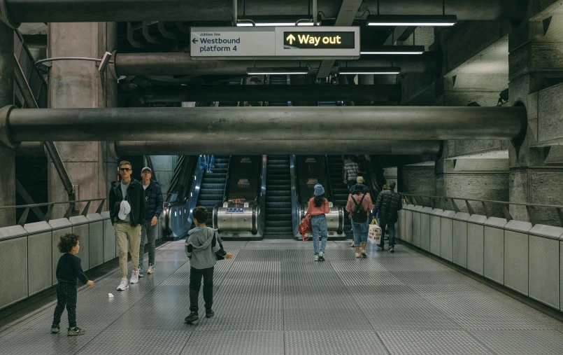 people walking on the floor of an underground subway station