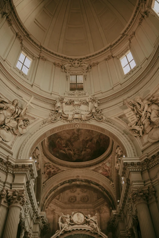 a church with high vaulted ceilings has an ornate ceiling