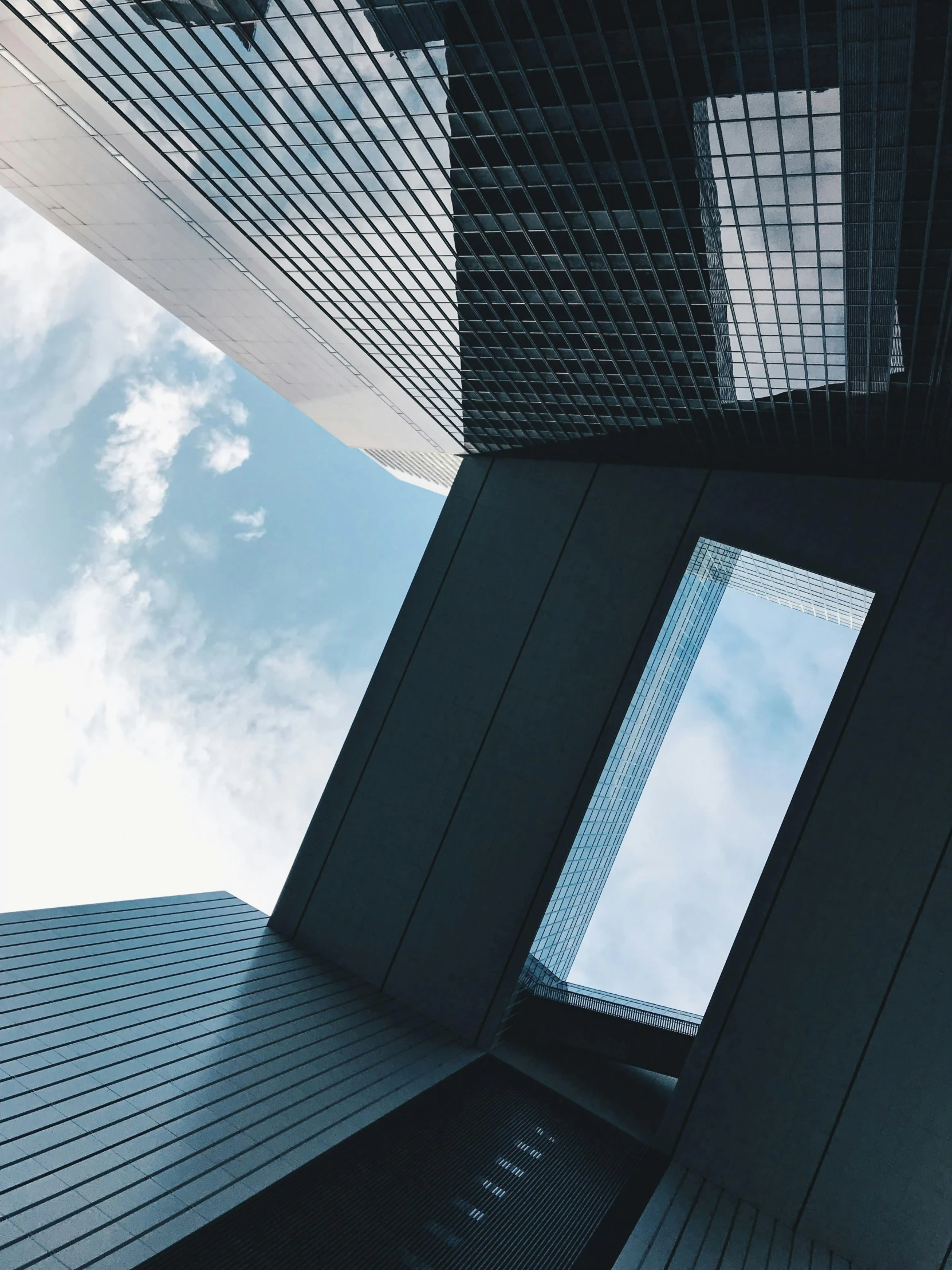 looking up at a very high rise building's glass windows