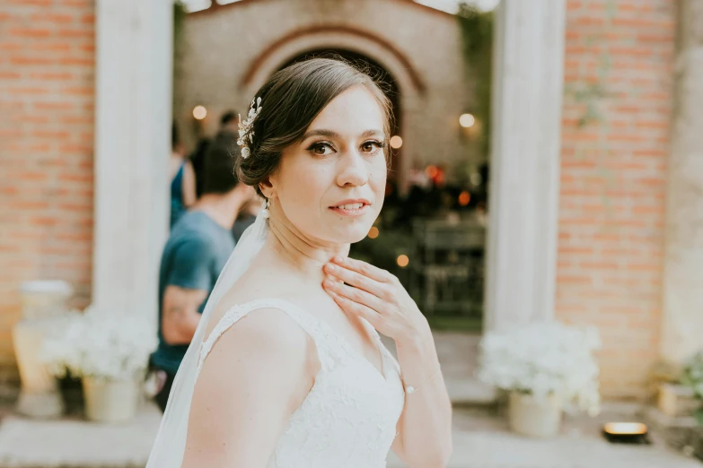 a woman in a wedding dress posing with another person