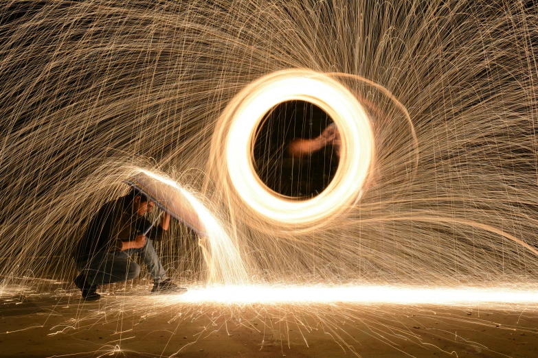 two men and a circular object made from fire