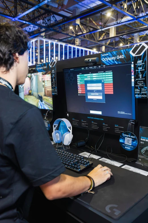 a man wearing headphones and playing on a computer