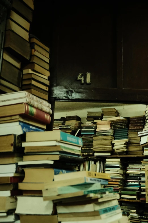 a very tall stack of books in a room