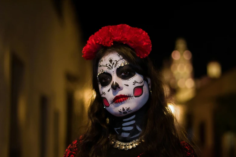 woman wearing makeup and decoration with red flower in her hair