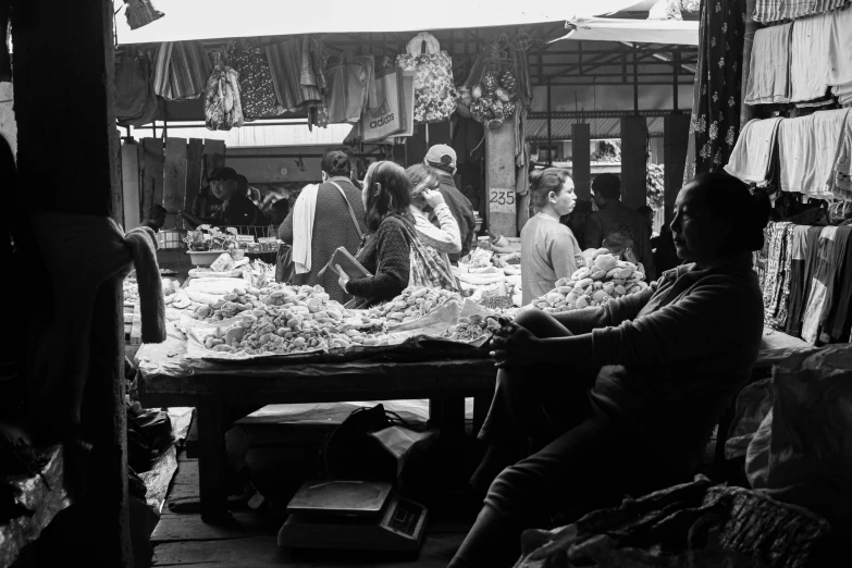 several people in an open market place on their own