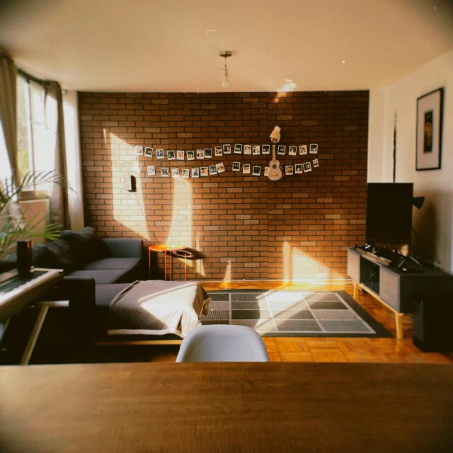 a living room filled with furniture and a brick wall