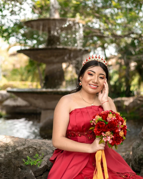 a woman in a red dress and a yellow sash