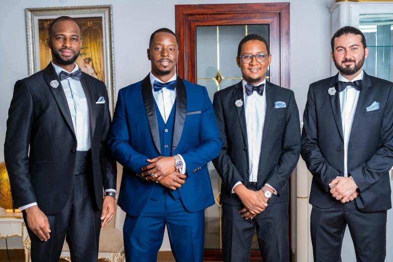 the grooms are ready to go in their suits for the wedding