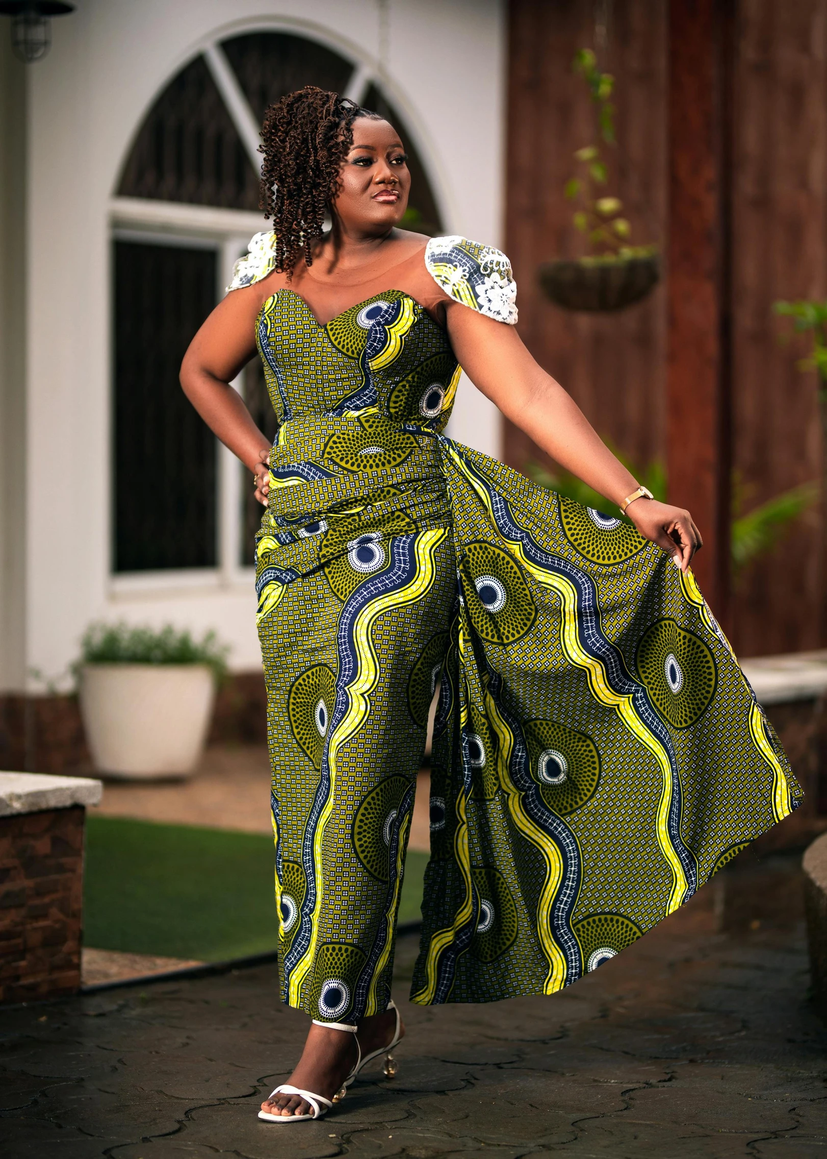 a woman in an unusually patterned jumpsuit poses for a po