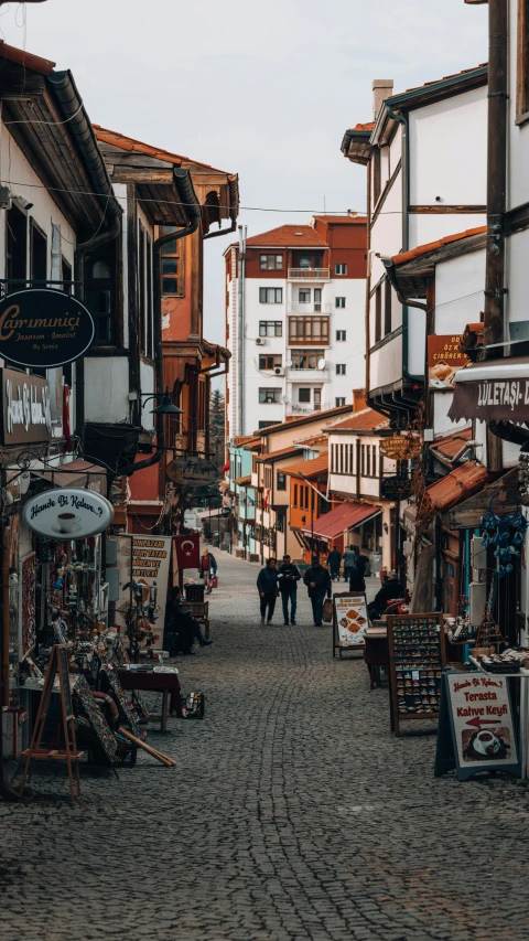 some people standing on a cobblestone road