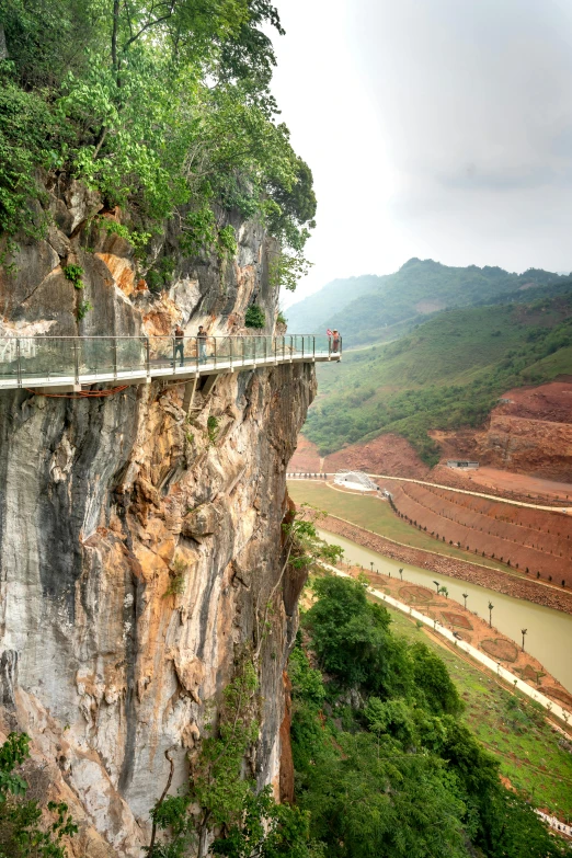 people are riding bicycles down the cliff over looking