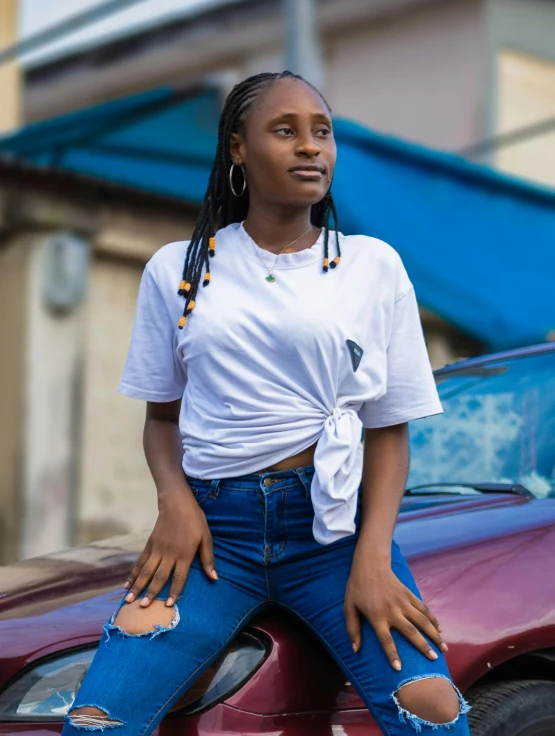 a woman is sitting on top of the car