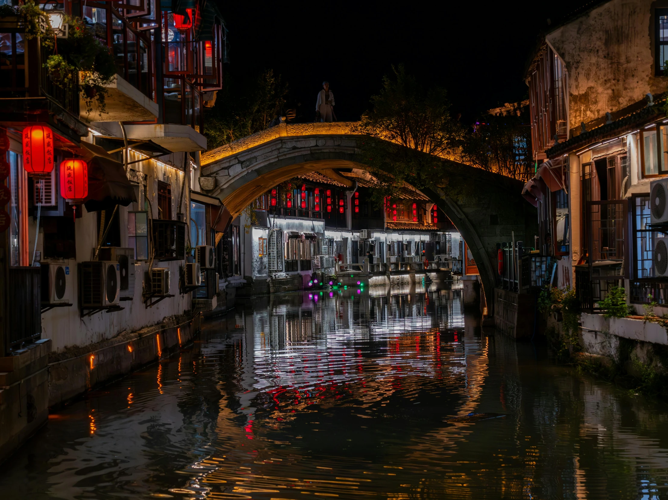 a canal surrounded by building next to traffic light