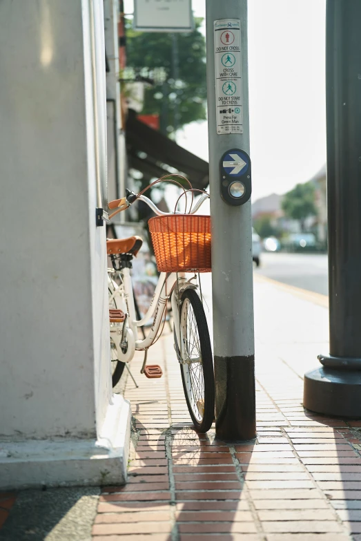 a bike is locked to a pole near a street