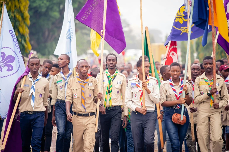 a group of people holding up flags during a rally