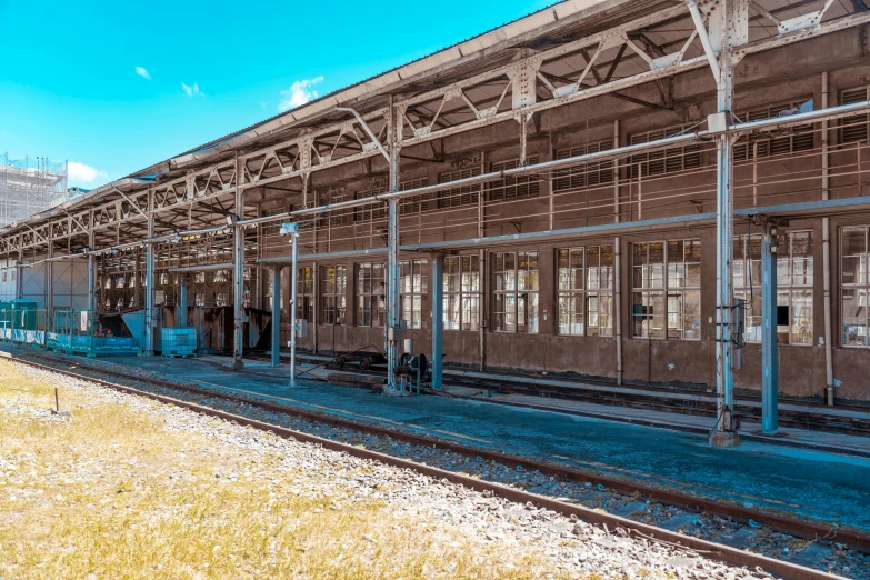 an old train station with multiple tracks and an empty platform