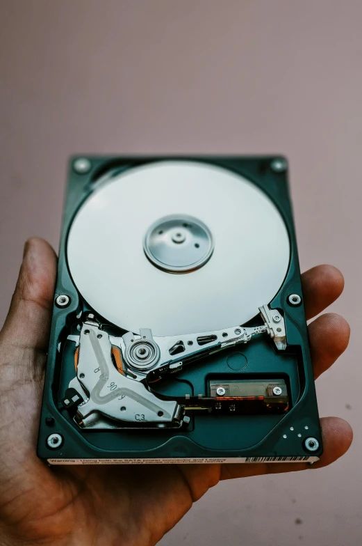 a person holding a hard drive in their hand