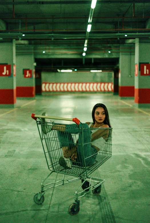 a child sitting in a shopping cart that is empty
