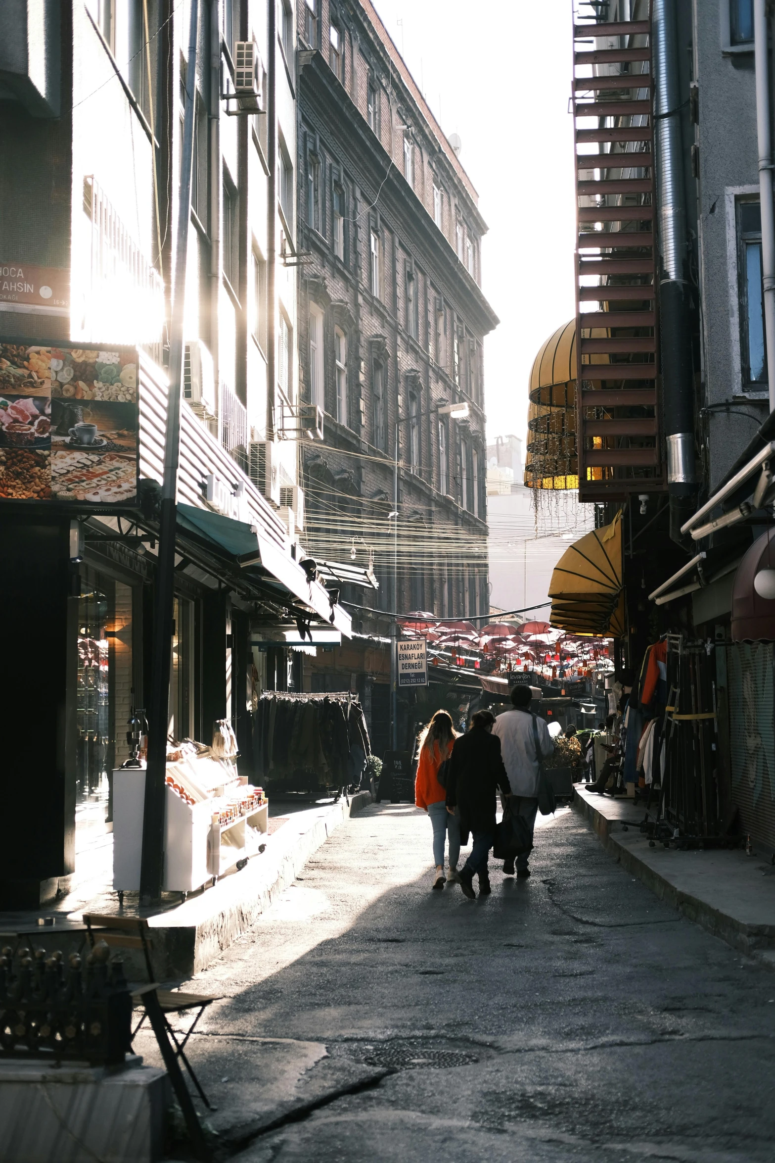 a group of people walking down the street of an old city