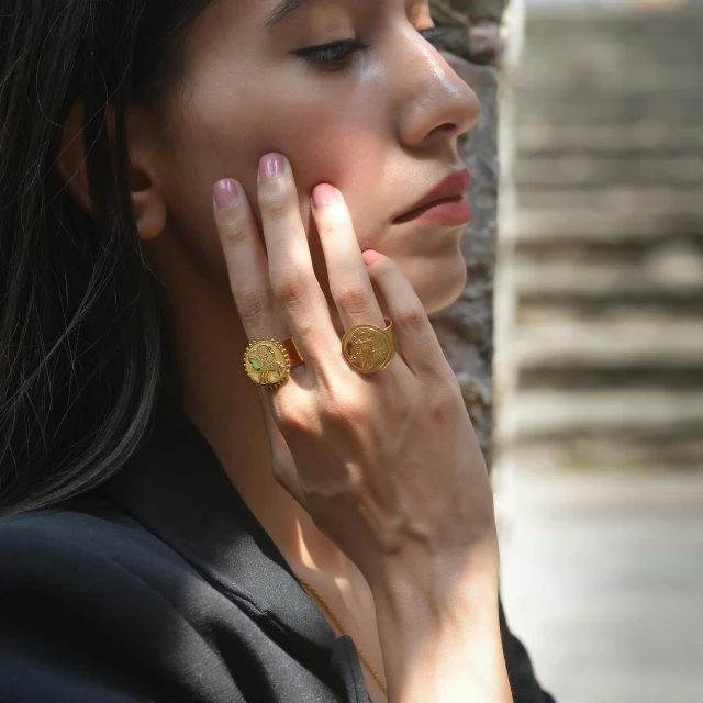 a close - up image of a woman with an intricate ring